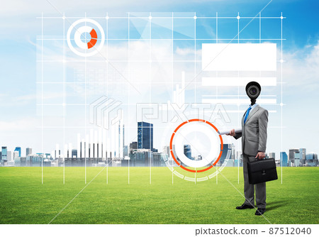 Camera headed man standing on green grass against modern cityscape Camera headed man standing on green grass against modern cityscape 87512040