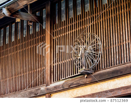Scenery of Tsumago-juku in winter, sunny in February, lattice windows and spinning wheel in a quaint cityscape Scenery of Tsumago-juku in winter, sunny in February, lattice windows and spinning wheel in a quaint cityscape 87512369