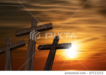 Three stone religious crosses against a beautiful sunset 87513252