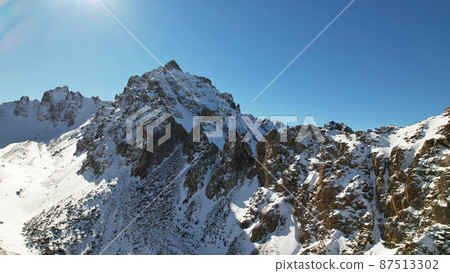 Drone view of the high snowy peaks of Kazakhstan 87513302