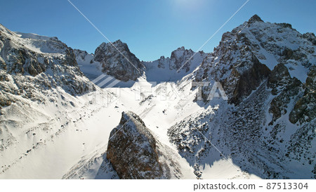 Drone view of the high snowy peaks of Kazakhstan 87513304