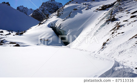 A huge crack in the ice. The entrance to the cave. 87513316