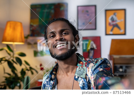 Happy young creative man looking at camera during livestream 87513466
