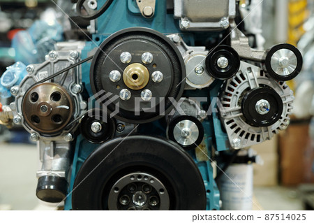Close-up of working engine of huge industrial machine with rotating shafts 87514025