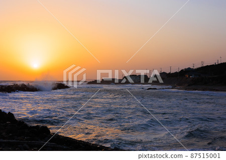 Sunset over the coastline 87515001