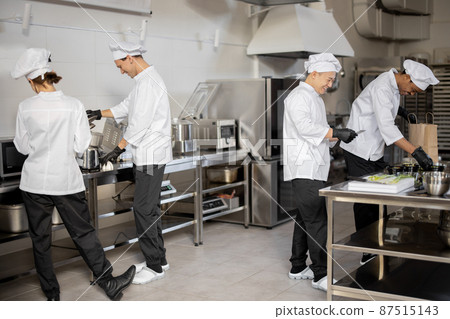 Happy multiracial team of cooks actively work in the kitchen 87515143