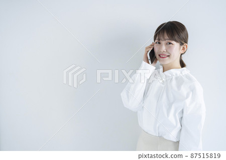 A woman using a mobile phone A woman using a mobile phone 87515819
