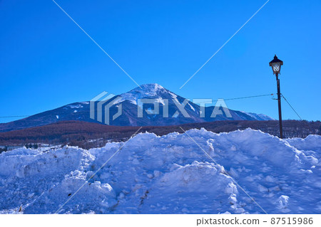 See Mt. Tateshina over the snow from the west side of Lake Shirakaba in Nagano Prefecture in winter 87515986