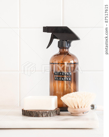 Amber bottle with washing solution, brush and soap on a marble shelf Amber bottle with washing solution, brush and soap on a marble shelf 87517615