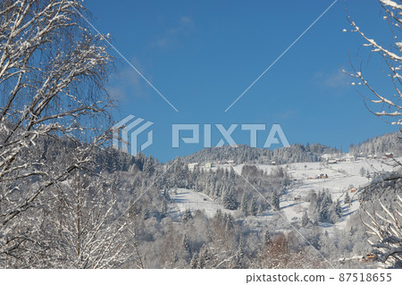 Rural hills, groves and agricultural lands in the winter remote Carpathian mountain village. brae Rural hills, groves and agricultural lands in the winter remote Carpathian mountain village. brae 87518655