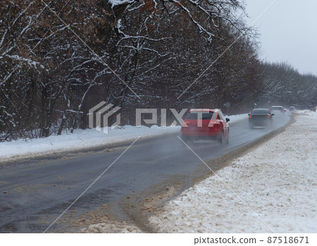 driving in winter after a snowfall, ice on the road, temperatures below zero driving in winter after a snowfall, ice on the road, temperatures below zero 87518671