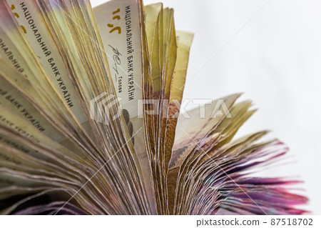 Ukrainian hryvnias bills lies isolated on white background with copy space stacked in fan close up. Payday time concept or financial operations Ukrainian hryvnias bills lies isolated on white background with copy space stacked in fan close up. Payday time concept or financial operations 87518702