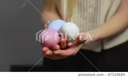Close-up of female hands holding Easter eggs. Christ is risen. Church holiday-Easter Close-up of female hands holding Easter eggs. Christ is risen. Church holiday-Easter 87520684