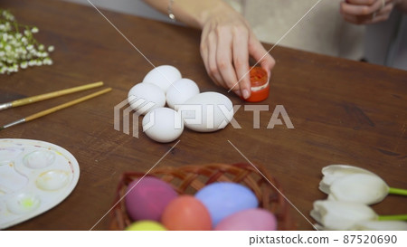 Close-up on a table with items to create a composition for Easter. Women's hands arrange objects on the table. Church holiday-Easter Close-up on a table with items to create a composition for Easter. Women's hands arrange objects on the table. Church holiday-Easter 87520690