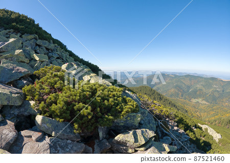 Rocky mountain hillside with big stone boulders on sunny day 87521460