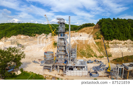 Cement factory at open pit mining of construction sand stone materials with excavators and dump trucks. Cement factory at open pit mining of construction sand stone materials with excavators and dump trucks. 87521859