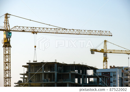 Aerial view of tower cranes and high residential apartment buildings under construction. Real estate development. Aerial view of tower cranes and high residential apartment buildings under construction. Real estate development. 87522002