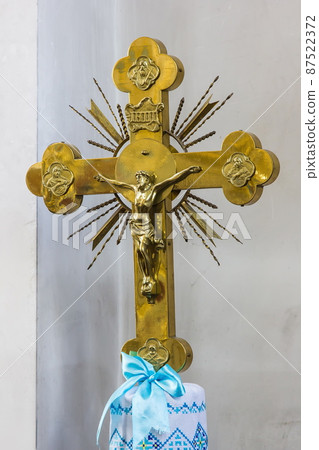 metal cross. golden color. Jesus, light background 87522372