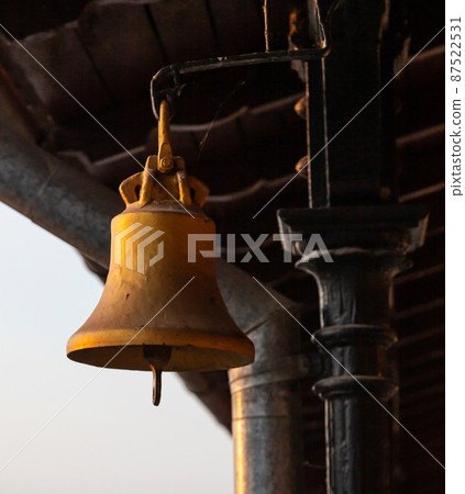 Copper old vintage bell. Decor concept element in the interior of a deck, cabin of a ship, restaurant, room, house, decorated on a marine theme Copper old vintage bell. Decor concept element in the interior of a deck, cabin of a ship, restaurant, room, house, decorated on a marine theme 87522531