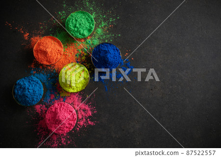 Happy Holi background. Organic colors powder in bowl for Holi festival. Happy Holi background. Organic colors powder in bowl for Holi festival. 87522557