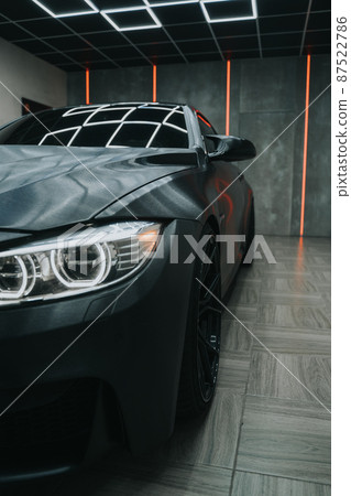 Sport car in parking with a red lines on a background  87522786