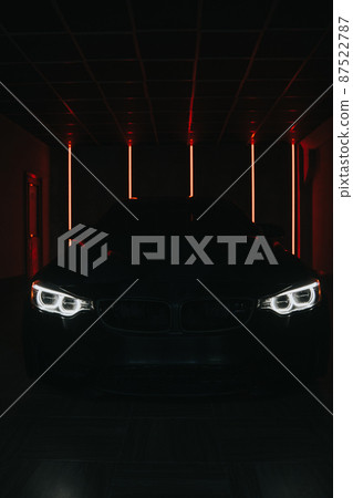 The car headlights burn in the dark. At night the car burns down the lights The car headlights burn in the dark. At night the car burns down the lights 87522787