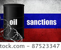 Oil sanctions against Russia barrel barbed wire Russian flag background 87523347