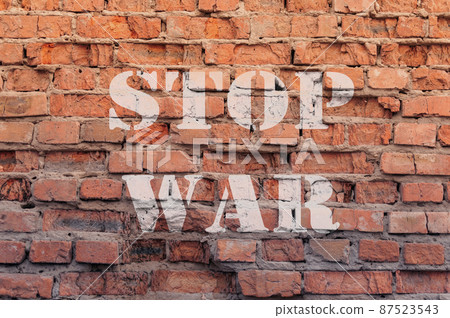stop war text on brick wall 87523543