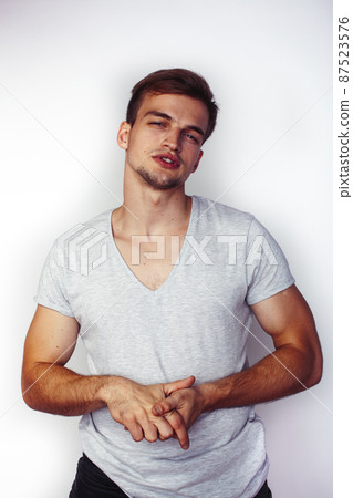 young handsome teenage hipster guy posing emotional, happy smiling against white background isolated, lifestyle people concept 87523576