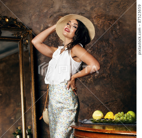 young pretty rich italian woman in golden luxury room interior, elegant styled hotel, people on vacation 87523659