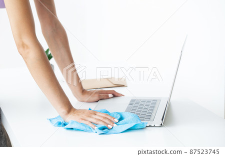 Woman disinfecting laptop keyboard with wet disinfectant wipes Woman disinfecting laptop keyboard with wet disinfectant wipes 87523745