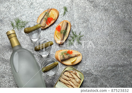 Flat lay composition with cold Russian vodka on grey table. Space for text 87523832