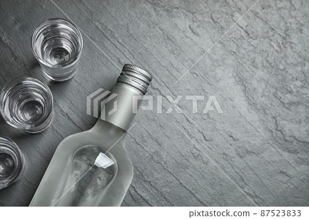 Cold Russian vodka on black table, flat lay. Space for text 87523833