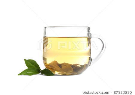 Cup of green tea and leaves isolated on white Cup of green tea and leaves isolated on white 87523850