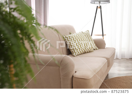 Modern comfortable sofa with pillows in living room. Stylish interior Modern comfortable sofa with pillows in living room. Stylish interior 87523875