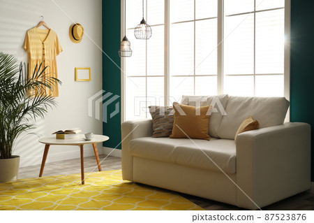 Modern comfortable sofa in stylish home interior Modern comfortable sofa in stylish home interior 87523876