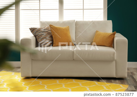 Modern comfortable sofa in stylish home interior Modern comfortable sofa in stylish home interior 87523877