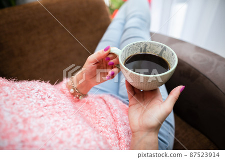 A woman holds a Turkish brewed coffee. View from above. A woman holds a Turkish brewed coffee. View from above. 87523914