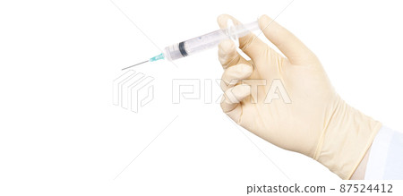 Hand holding syringe with vaccine against corona virus. 87524412