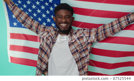 Man waving, wrapping in American USA flag, celebrating, human rights, freedoms, Independence Day Man waving, wrapping in American USA flag, celebrating, human rights, freedoms, Independence Day 87525544