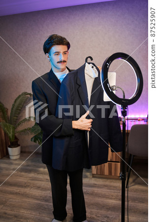 Metrosexual male person looking at the smartphone camera while recording video 87525907