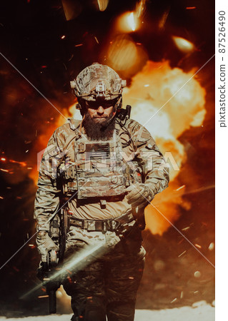 A bearded soldier in a special forces uniform walks through an abandoned building after a successful mission. Selection focus 87526490