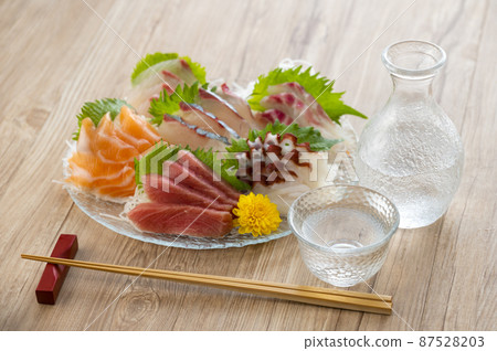 Sashimi and sake served on a glass plate Sashimi and sake served on a glass plate 87528203