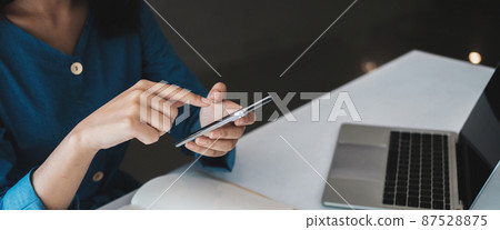 Crop close up of woman hold modern smartphone gadget look at screen text or message online. Asian female use cellphone browse surf wireless internet on device. Communication, technology concept 87528875