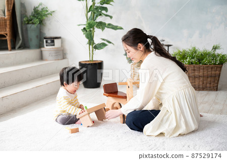 A beautiful new mom who comforts her baby 87529174