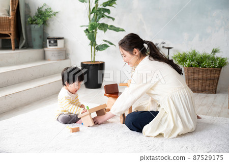 A beautiful new mom who comforts her baby 87529175