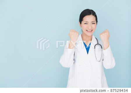 Female doctor doing a guts pose 87529434