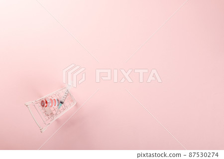 Shopping cart with vaccine vials bottles and syringes for vaccination against coronavirus Shopping cart with vaccine vials bottles and syringes for vaccination against coronavirus 87530274