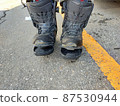 Snowboard boots that have deteriorated and the sole has peeled off 87530944
