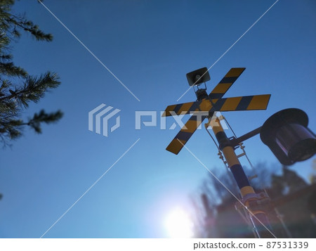 Railroad crossing in the clear blue sky Railroad crossing in the clear blue sky 87531339